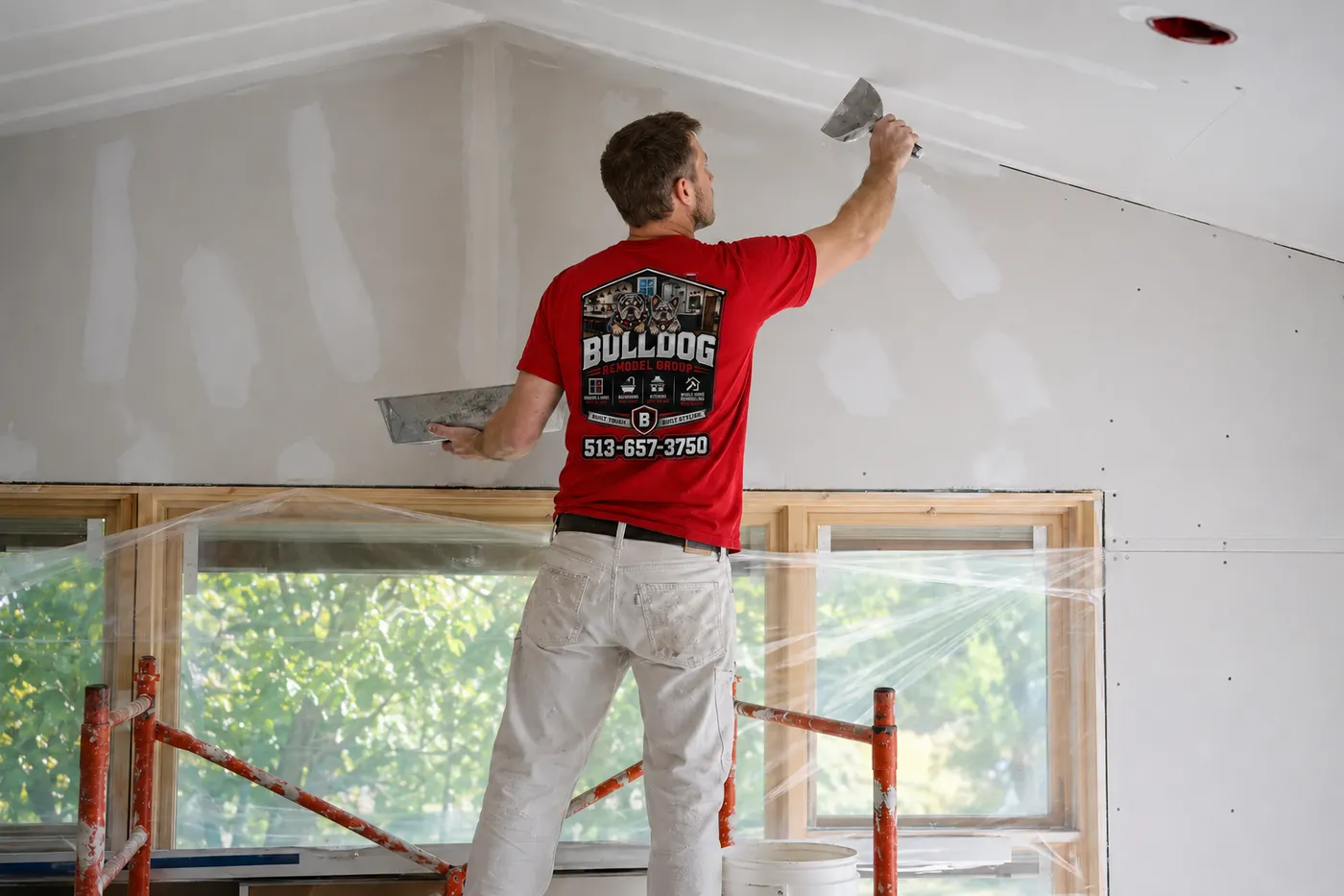 Bulldog Remodel Group technician framing and finishing drywall during a basement remodel