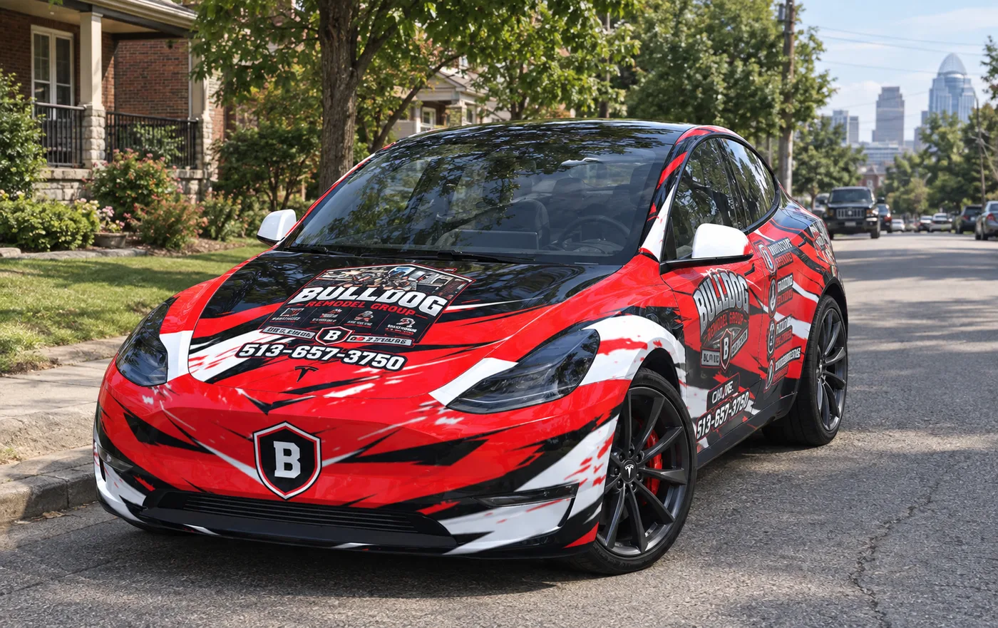Bulldog Remodel Group's red, black and white wrapped Tesla parked on a Cincinnati street